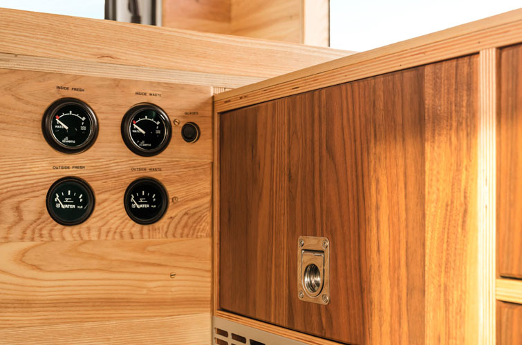 Cabinet detail of campervan interior. Wooden optic. Cabinet with integrated design opening system. Sideboard with round vehicle measurements.
