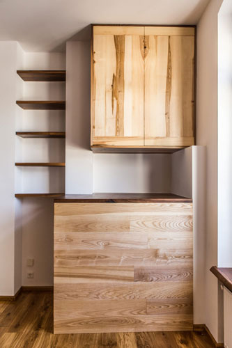 Combination of desk shelve with cabinet above and solid wood shelves on the side.