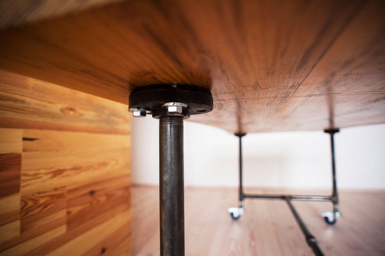 Bright wooden cabinet with dark wooden knobs and grain pattern. Close shot front.